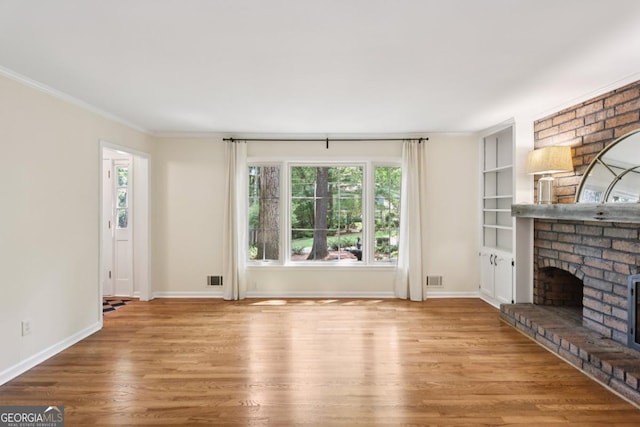 5240 Arrie Way, Atlanta, GA 30360 - unfurnished living room with plenty of natural light, wood finished floors, a brick fireplace, baseboards, and crown molding
