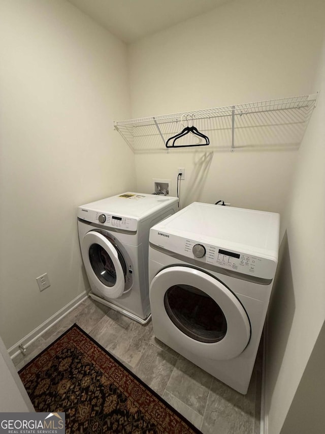 3378 English Elm Way, Loganville, GA 30052 - laundry room with washer and clothes dryer, baseboards, and wood finished floors