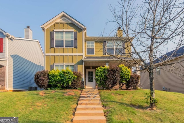 171 Stillwood Dr, Newnan, GA 30265 - view of front of home featuring board and batten siding, a front yard, and a chimney