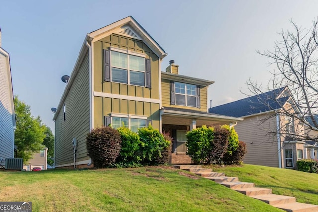 171 Stillwood Dr, Newnan, GA 30265 - view of front of house featuring board and batten siding, a front lawn, and a chimney