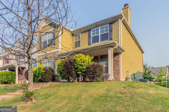171 Stillwood Dr, Newnan, GA 30265 - traditional-style home featuring a chimney, a front lawn, and brick siding