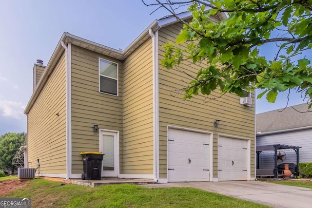 171 Stillwood Dr, Newnan, GA 30265 - back of property featuring a garage, concrete driveway, a chimney, and a lawn