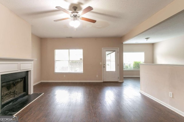 171 Stillwood Dr, Newnan, GA 30265 - unfurnished living room featuring a fireplace, a ceiling fan, and dark wood-type flooring