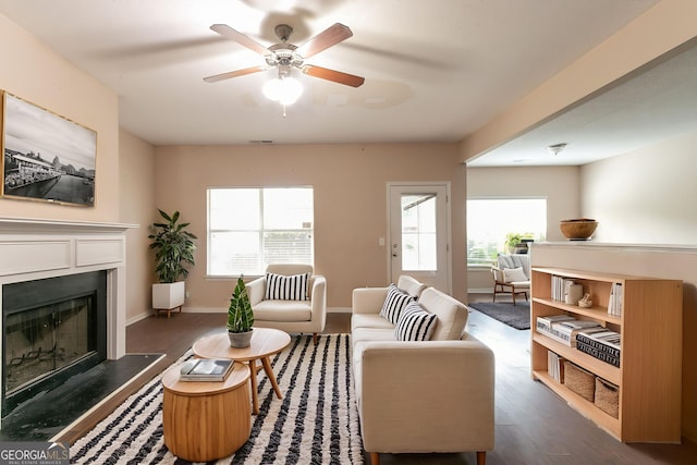 171 Stillwood Dr, Newnan, GA 30265 - living area featuring dark wood-type flooring, a fireplace, and a ceiling fan