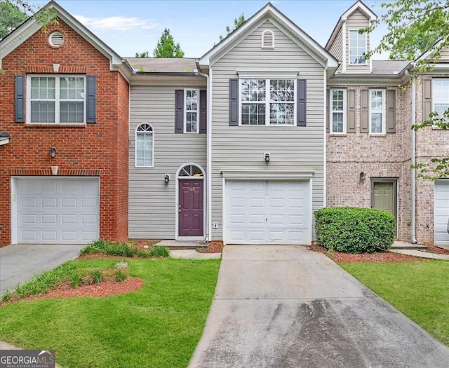 780 Nehemiah Ln SW, Atlanta, GA 30331 - view of property featuring concrete driveway, a garage, a front lawn, and brick siding