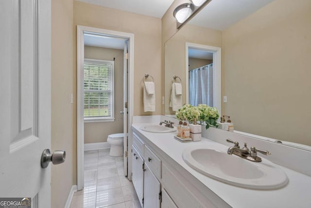 1777 E Gate Trl, Stone Mountain, GA 30087 - bathroom featuring toilet, double vanity, baseboards, and tile patterned floors