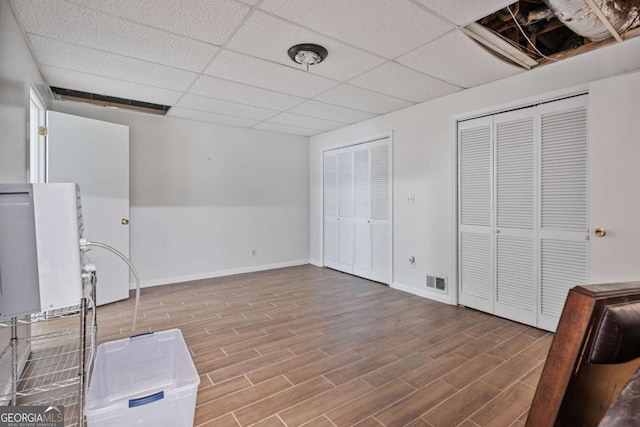1777 E Gate Trl, Stone Mountain, GA 30087 - misc room with wood finished floors, a drop ceiling, and baseboards