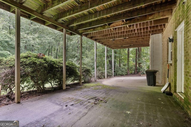 1777 E Gate Trl, Stone Mountain, GA 30087 - view of patio / terrace with a carport and a forest view