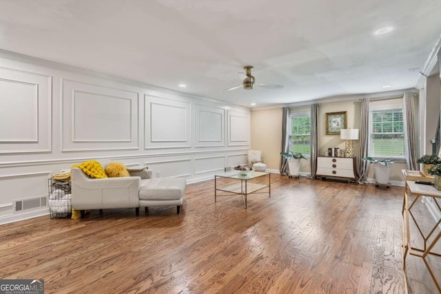 1777 E Gate Trl, Stone Mountain, GA 30087 - living area featuring a decorative wall, ceiling fan, wood finished floors, crown molding, and recessed lighting