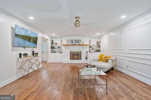 1777 E Gate Trl, Stone Mountain, GA 30087 - living area with ceiling fan, wood finished floors, a stone fireplace, recessed lighting, and a decorative wall