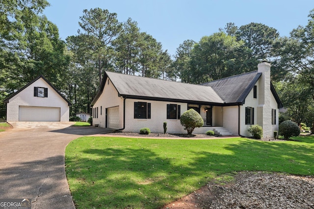 130 Emerald Dr, Mcdonough, GA 30253 - view of front of property featuring a detached garage, a chimney, brick siding, and a front yard
