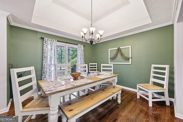 130 Emerald Dr, Mcdonough, GA 30253 - dining space featuring a tray ceiling, a chandelier, wood finished floors, and ornamental molding