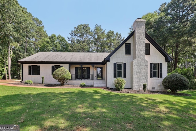 130 Emerald Dr, Mcdonough, GA 30253 - view of front of house featuring brick siding, a chimney, a front yard, and a porch