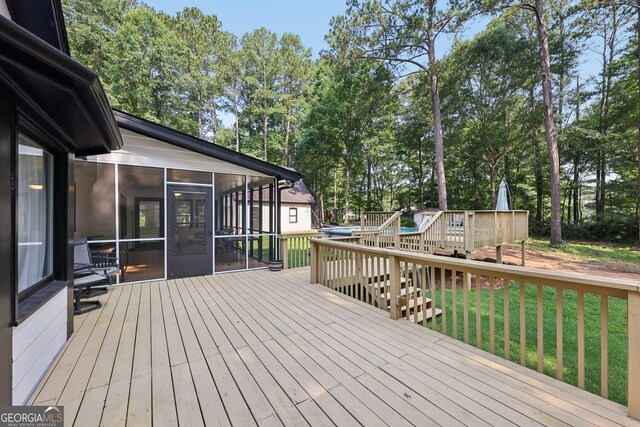 130 Emerald Dr, Mcdonough, GA 30253 - wooden deck featuring a sunroom, a lawn, and view of scattered trees