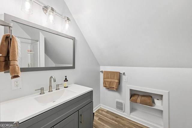 130 Emerald Dr, Mcdonough, GA 30253 - bathroom with vaulted ceiling, vanity, wood finished floors, and heating unit