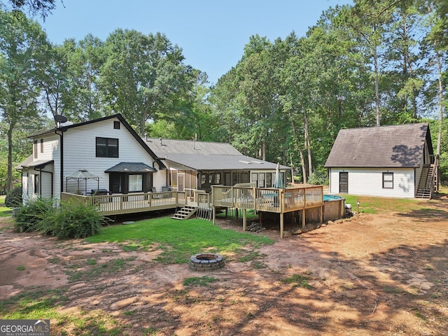 130 Emerald Dr, Mcdonough, GA 30253 - rear view of house featuring an outdoor fire pit and a wooden deck