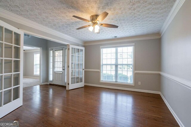 2482 Brittany Park Ln, Ellenwood, GA 30294 - empty room with french doors, wood finished floors, ceiling fan, and baseboards