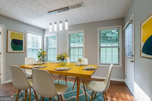 2482 Brittany Park Ln, Ellenwood, GA 30294 - dining room with a textured ceiling, wood finished floors, baseboards, and plenty of natural light