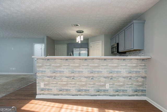 2482 Brittany Park Ln, Ellenwood, GA 30294 - kitchen featuring stainless steel appliances, baseboards, dark wood-type flooring, and gray cabinets