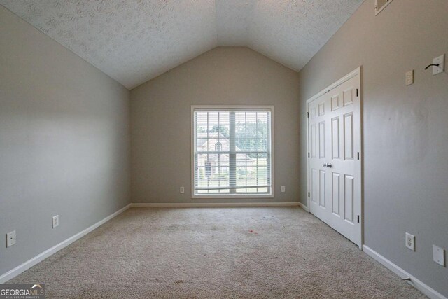 2482 Brittany Park Ln, Ellenwood, GA 30294 - unfurnished bedroom with light colored carpet, a textured ceiling, baseboards, a closet, and ceiling fan