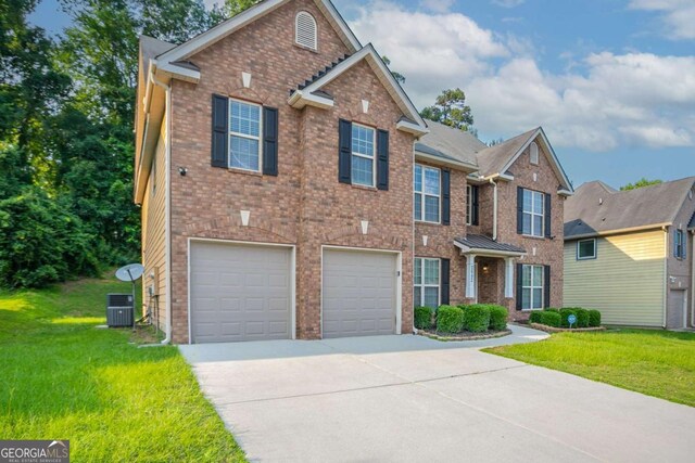 2482 Brittany Park Ln, Ellenwood, GA 30294 - view of front facade with concrete driveway, brick siding, and a front yard