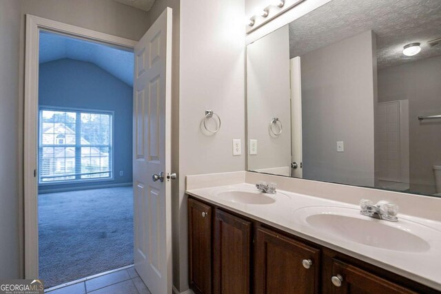 2482 Brittany Park Ln, Ellenwood, GA 30294 - bathroom with double vanity, toilet, tile patterned floors, and a textured ceiling
