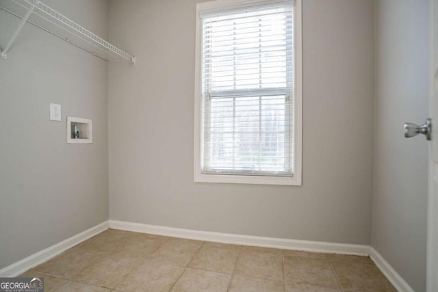 2482 Brittany Park Ln, Ellenwood, GA 30294 - laundry area with healthy amount of natural light, washer hookup, baseboards, and light tile patterned floors