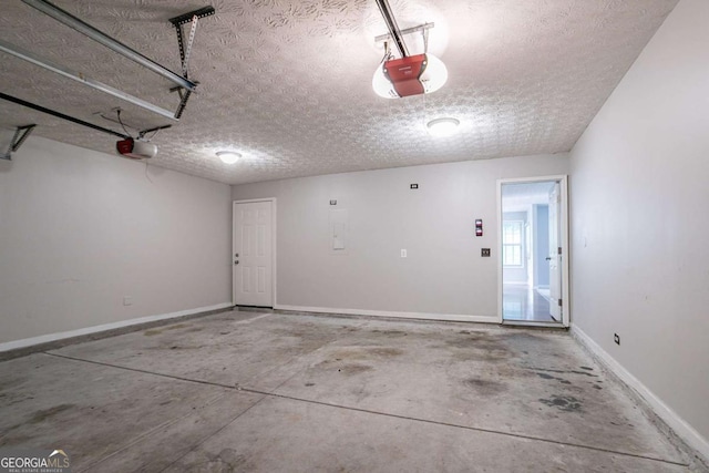 2482 Brittany Park Ln, Ellenwood, GA 30294 - garage with a garage door opener and baseboards