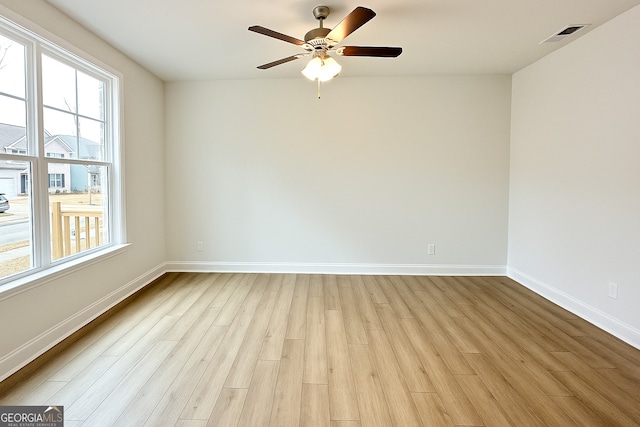 3468 Jasmine Way SW, South Fulton, GA 30331 - unfurnished room with plenty of natural light, light wood-style flooring, baseboards, and a ceiling fan