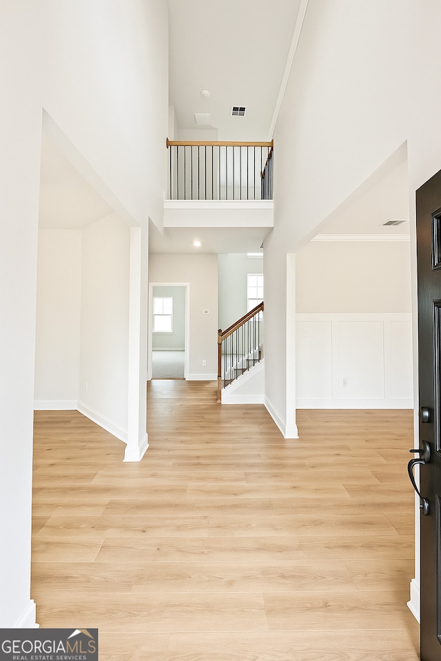 3468 Jasmine Way SW, South Fulton, GA 30331 - foyer entrance featuring a towering ceiling, stairs, light wood-style floors, and baseboards