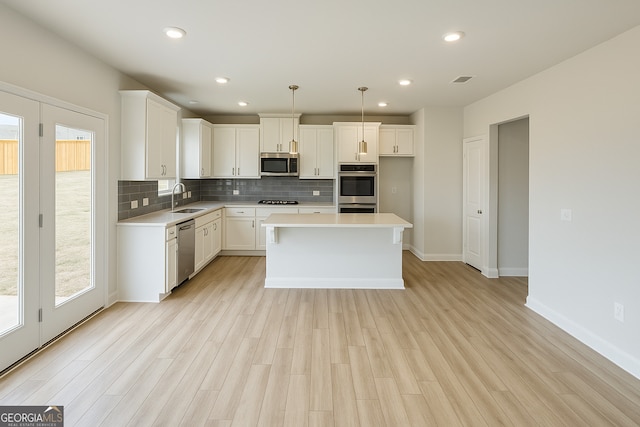 3468 Jasmine Way SW, South Fulton, GA 30331 - kitchen with stainless steel appliances, a sink, backsplash, light countertops, and baseboards