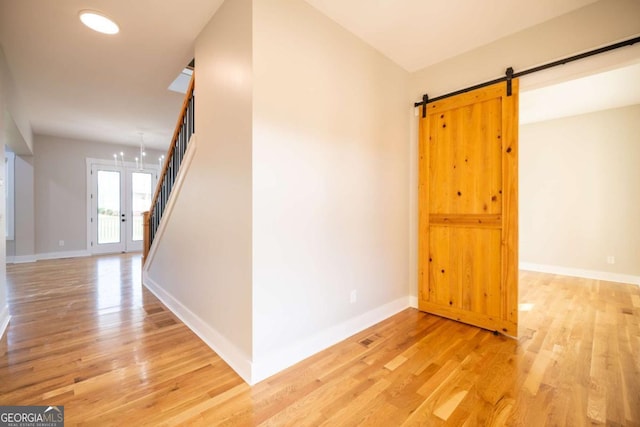 982 Wildberry Ct, Jefferson, GA 30549 - unfurnished room with stairs, light wood-style flooring, and baseboards