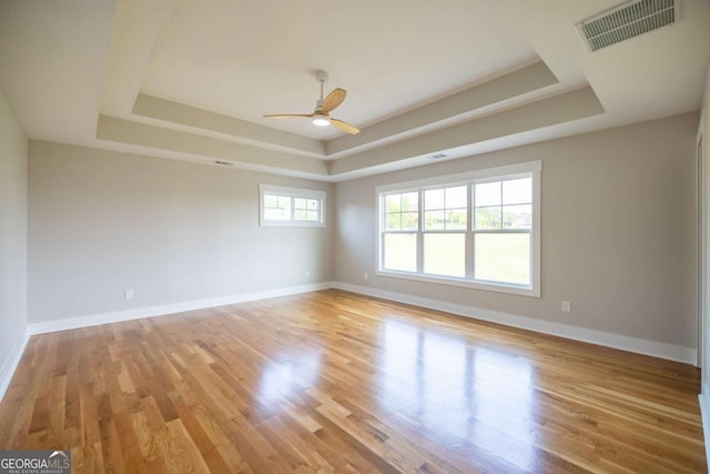982 Wildberry Ct, Jefferson, GA 30549 - unfurnished room with a tray ceiling, a ceiling fan, baseboards, and light wood-style floors