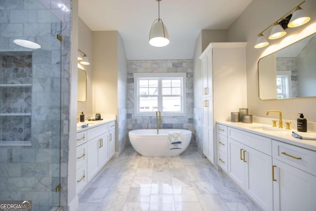 982 Wildberry Ct, Jefferson, GA 30549 - bathroom with vanity, marble finish floors, a freestanding tub, a shower stall, and tile walls