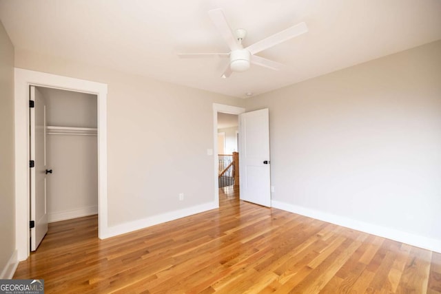 982 Wildberry Ct, Jefferson, GA 30549 - unfurnished bedroom with light wood finished floors, baseboards, a closet, and a ceiling fan
