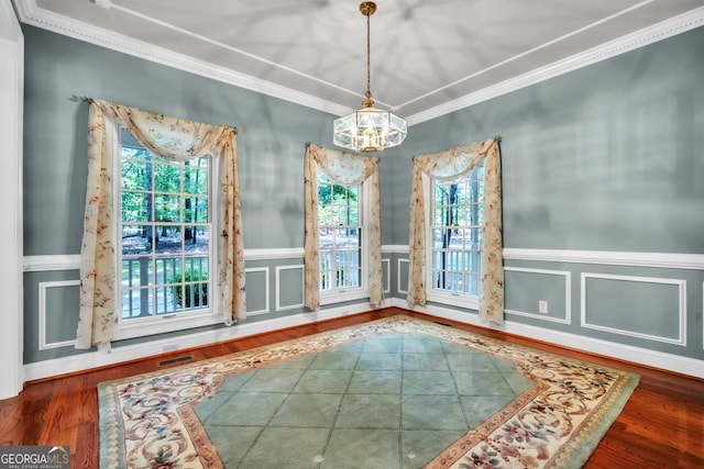 242 Pristine Cv, Hartwell, GA 30643 - unfurnished dining area featuring ornamental molding, a chandelier, wainscoting, and wood finished floors