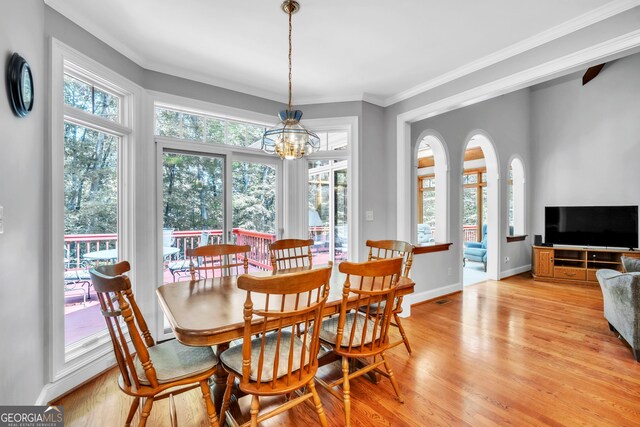 242 Pristine Cv, Hartwell, GA 30643 - dining space featuring light wood-type flooring, a chandelier, crown molding, and baseboards