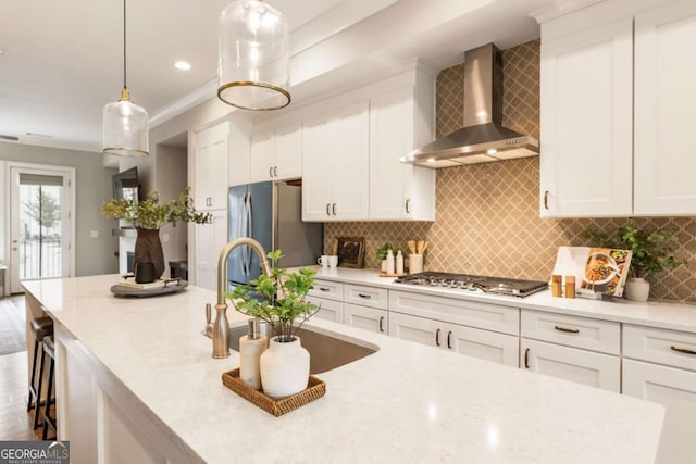 6613 Encore Blvd, Atlanta, GA 30328 - kitchen featuring wall chimney exhaust hood, stainless steel appliances, a sink, white cabinets, and hanging light fixtures