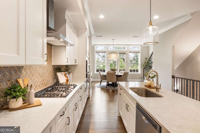 6613 Encore Blvd, Atlanta, GA 30328 - kitchen featuring wall chimney exhaust hood, appliances with stainless steel finishes, a sink, dark wood-style flooring, and decorative light fixtures