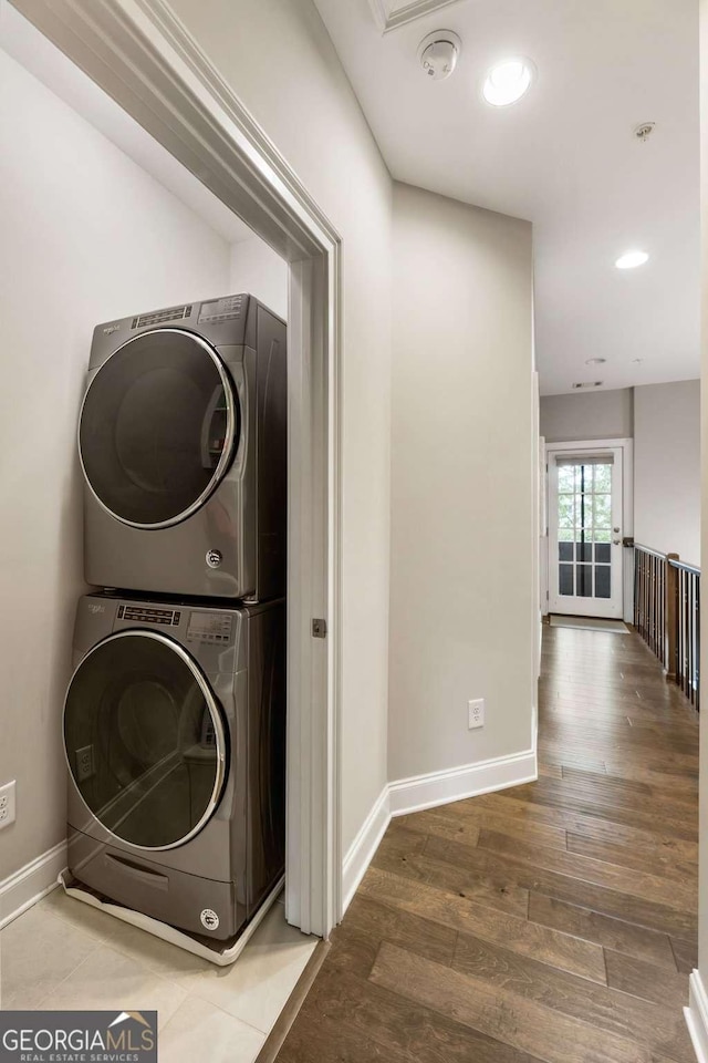 6613 Encore Blvd, Atlanta, GA 30328 - washroom featuring stacked washing machine and dryer, wood finished floors, baseboards, and recessed lighting