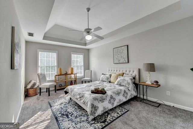 4901 Briarleigh Chase SW, Mableton, GA 30126 - carpeted bedroom with a tray ceiling and ceiling fan