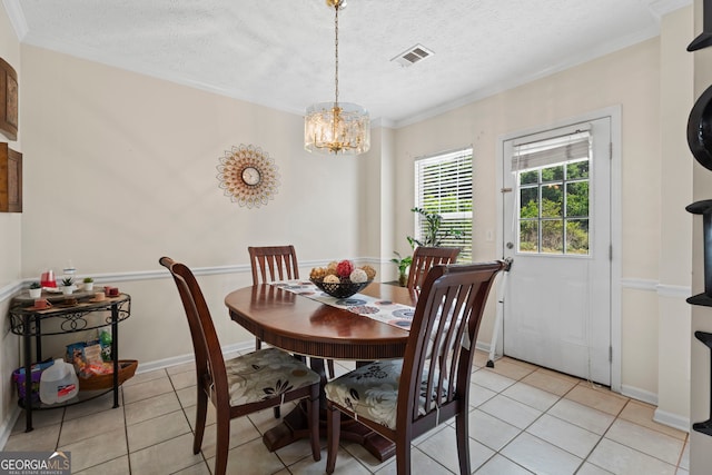 8180 Chapman Ter, Mcdonough, GA 30252 - dining area featuring light tile patterned flooring, crown molding, a textured ceiling, a chandelier, and baseboards