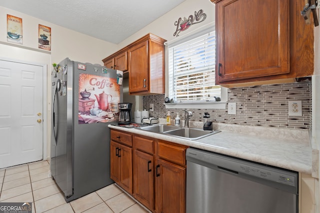 8180 Chapman Ter, Mcdonough, GA 30252 - kitchen with stainless steel appliances, a sink, light tile patterned floors, light countertops, and decorative backsplash