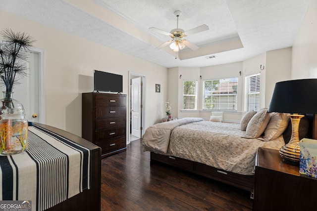 8180 Chapman Ter, Mcdonough, GA 30252 - bedroom with a raised ceiling, hardwood / wood-style floors, a textured ceiling, and a ceiling fan