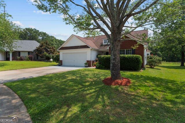 8180 Chapman Ter, Mcdonough, GA 30252 - view of front of home featuring brick siding, concrete driveway, a front lawn, and a garage