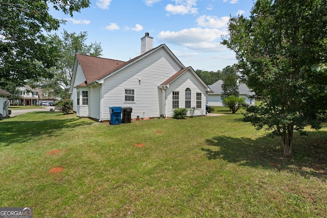 8180 Chapman Ter, Mcdonough, GA 30252 - rear view of property with a chimney and a yard