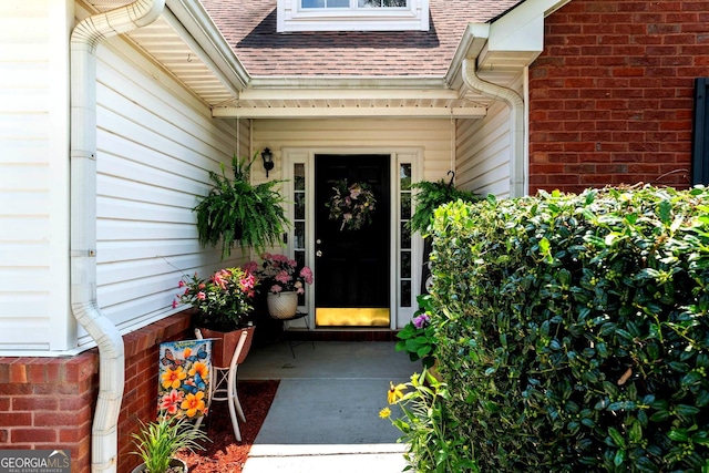 8180 Chapman Ter, Mcdonough, GA 30252 - doorway to property with roof with shingles and brick siding
