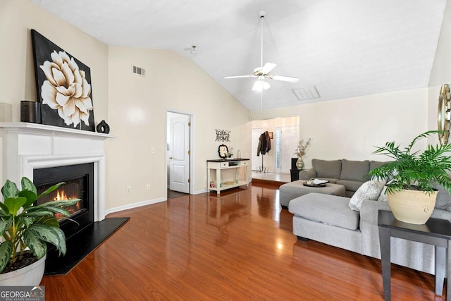 8180 Chapman Ter, Mcdonough, GA 30252 - living room featuring lofted ceiling, a ceiling fan, wood finished floors, and a glass covered fireplace