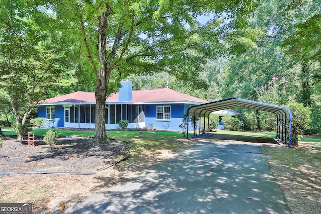 766 Blanton Blvd, Macon, GA 31210 - ranch-style home with asphalt driveway, a sunroom, a detached carport, and a chimney