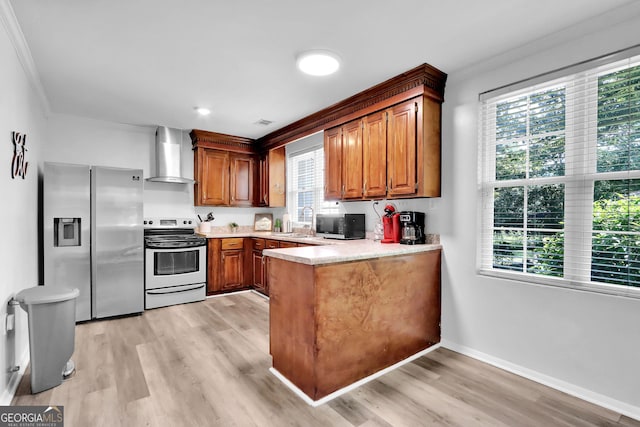 766 Blanton Blvd, Macon, GA 31210 - kitchen featuring appliances with stainless steel finishes, wall chimney exhaust hood, a peninsula, ornamental molding, and light wood-type flooring